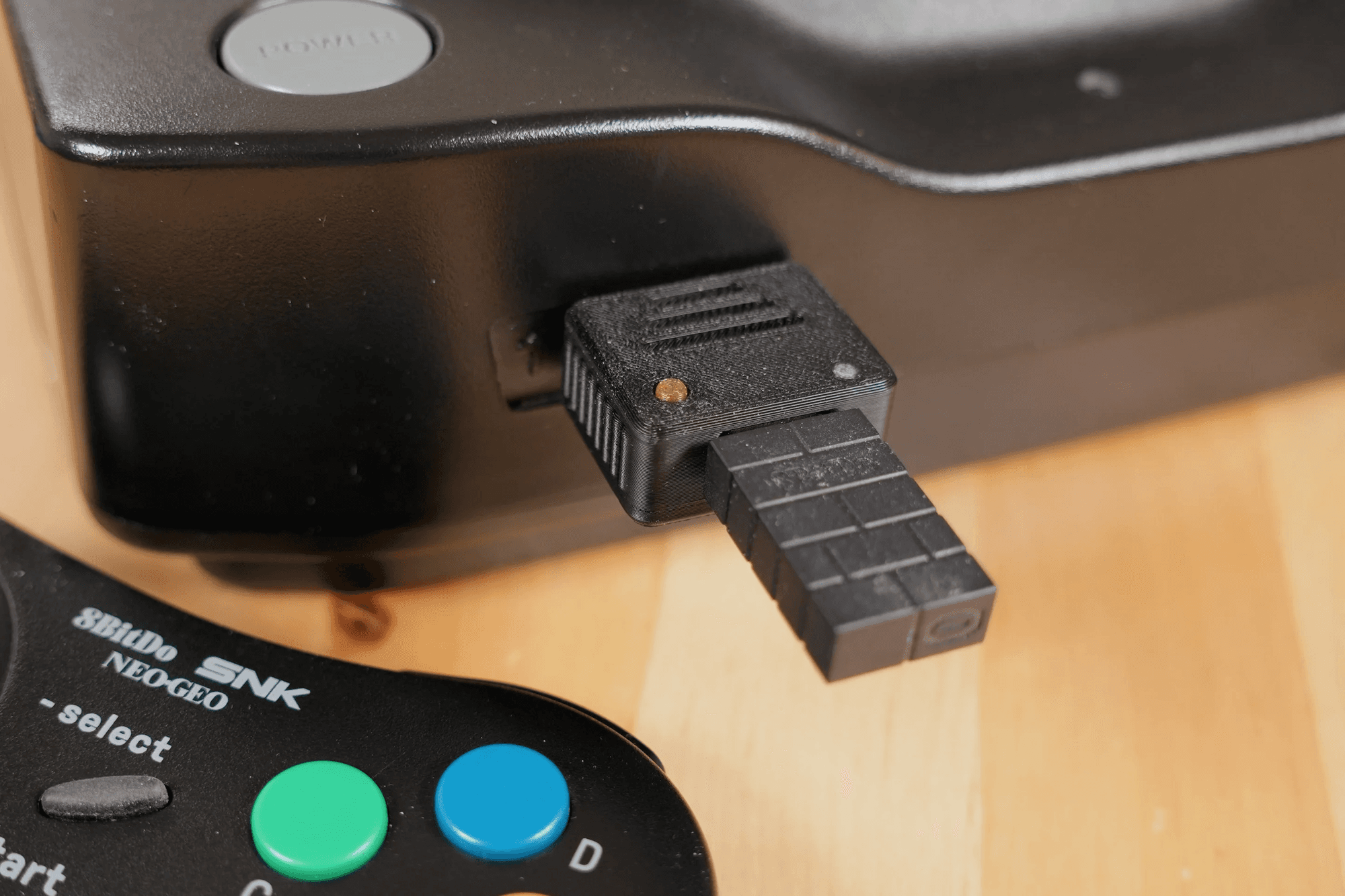 USB4NEO adapter plugged into an SNK Neo Geo console