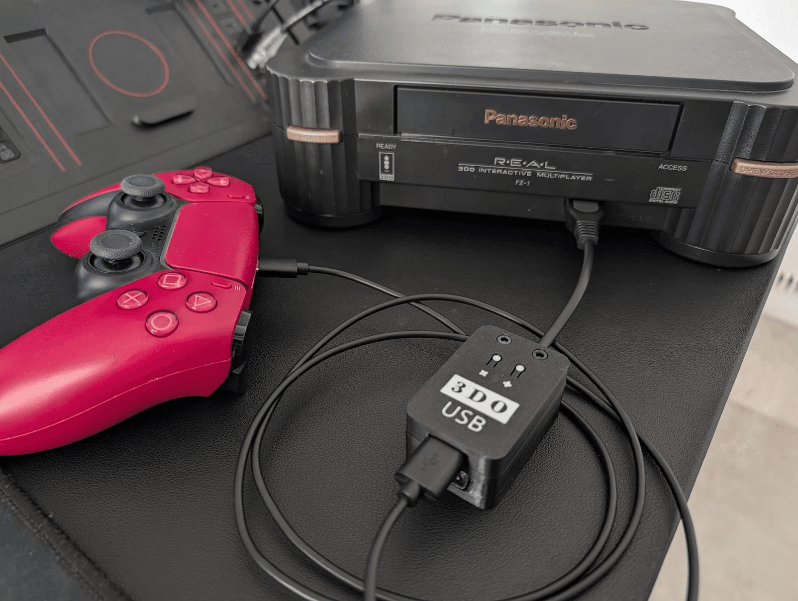 USB23DO adapter connecting a DualSense controller to a Panasonic 3DO FZ-1